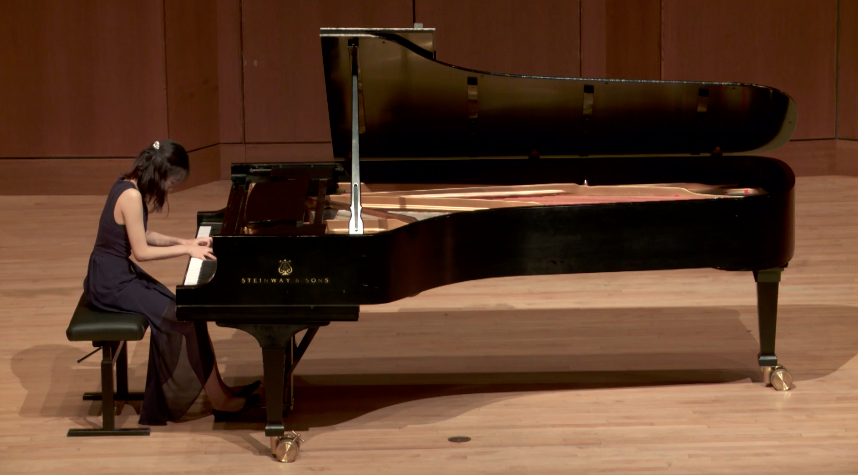 Ashley Chung performing on a Steinway grand piano on stage