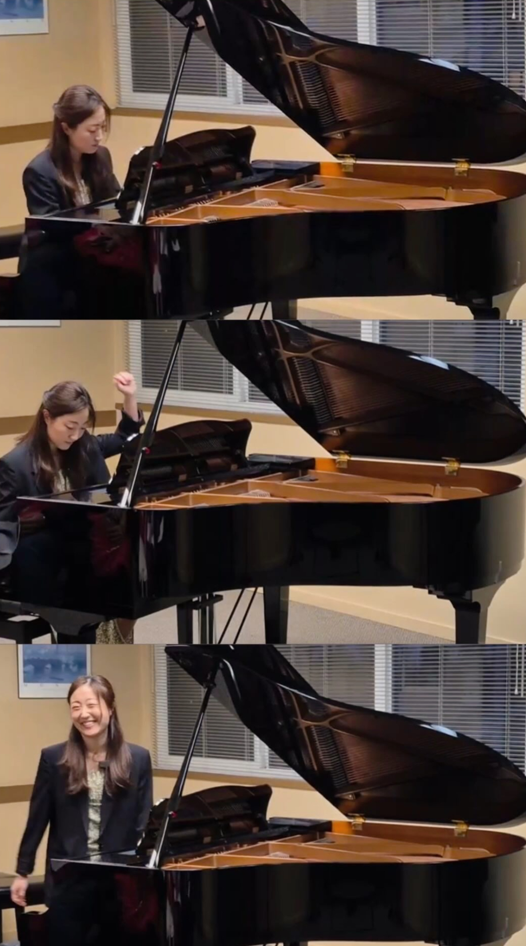 Ashley Chung playing and standing beside a grand piano in a rehearsal room